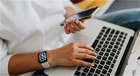 Person on phone with laptop