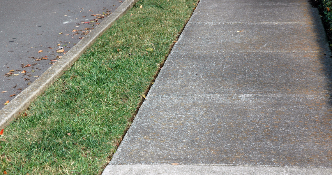 Sidewalk with small strip of grass